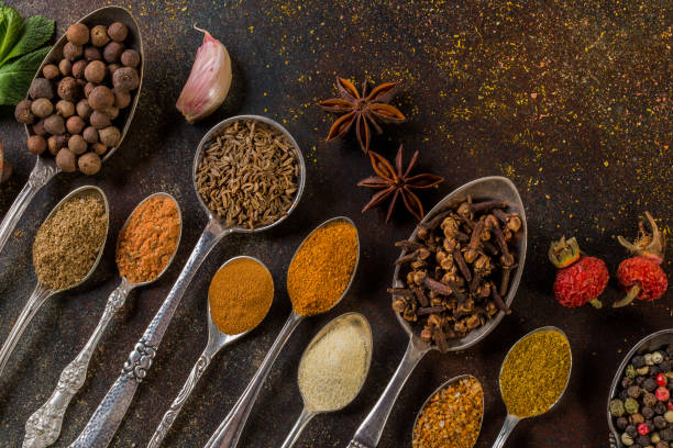 istock Various spices seasonings in antique spoons on a dark table. Cookery idea top view. 1138024183