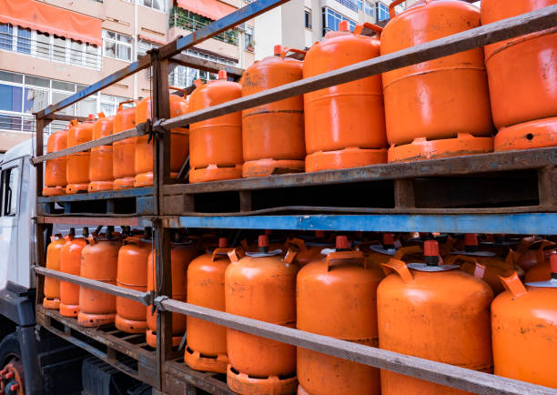 Truck full of orange gas cylinders Truck full of orange gas cylinders transporting butane butane photos stock pictures, royalty-free photos & images
