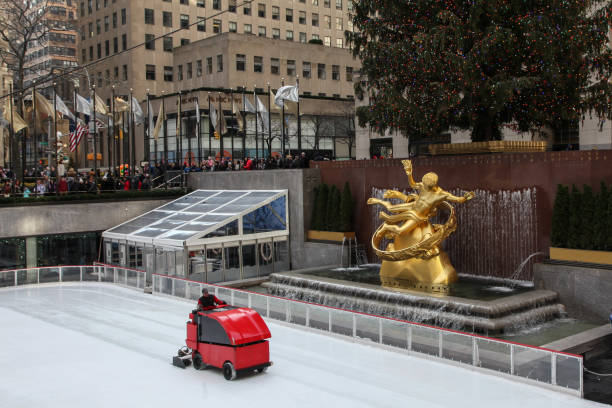 Ice ring with ice resurfacing and repairing the machine New York City, New York, USA - December 27, 2018: Ice ring with ice resurfacing and repairing the machine and with Christmas tree at Rockefeller Centre. rockefeller ice rink stock pictures, royalty-free photos & images