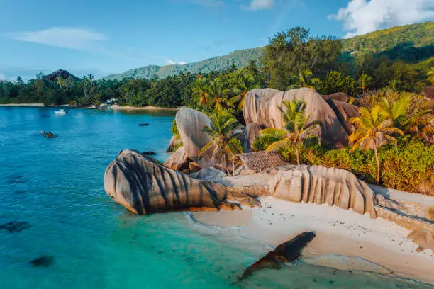 Photo of Anse Source D Argent beach, Seychelles. Aerial drone photo of unique tropical island landscape at warm sunset light