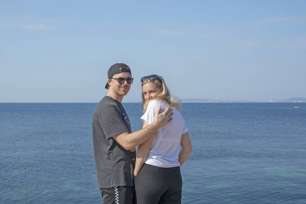 istock Young smiling handsome man with cap backwards and beautiful blonde woman looking 1138036801