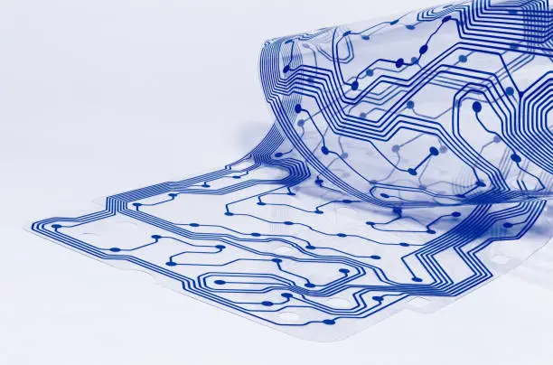 Flexible silicone sheet. PCB detail curled to a roll. Electrical contact. Abstract bent plastic film. Drafting. Blue pattern. White background