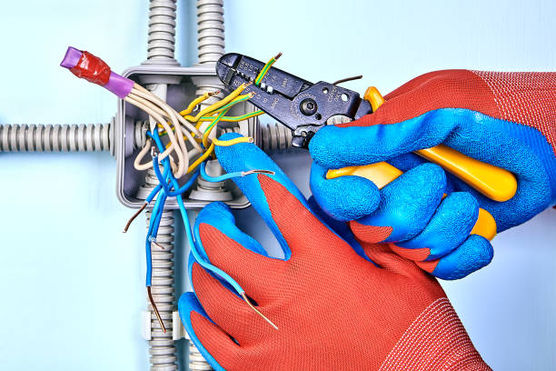 istock Electrician removes insulation from wires. 1138036980
