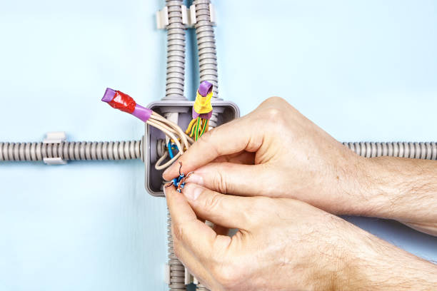 istock Twisting ends of wires together. 1138036983