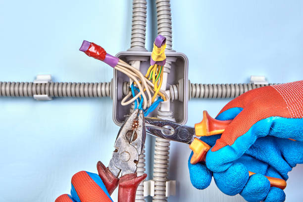 twisting wires with needle-nose pliers. - splice imagens e fotografias de stock