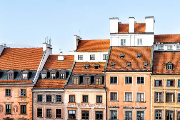 Warsaw, Poland red orange roof in old town market square with historic street town architecture and windows rooftop closeup pattern