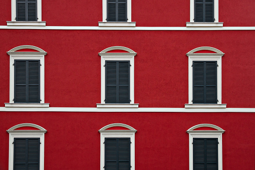 old windows with red white shutters