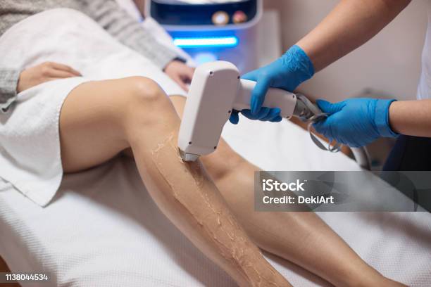 Beautician Removing Hair With Laser Epilator Stock Photo - Download Image Now - Hair Removal, Laser, Medical Laser