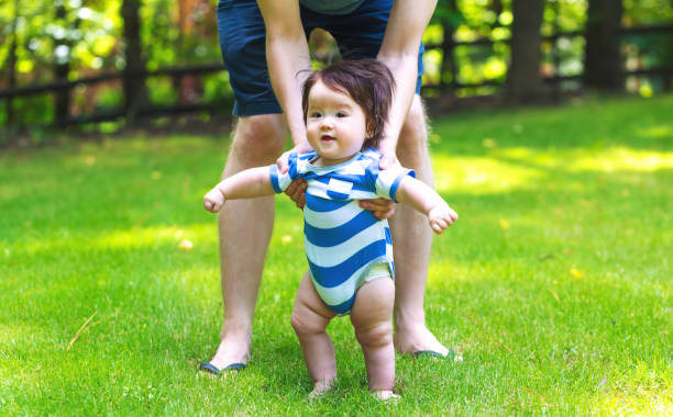 istock Baby boy learning to walk outside 1138048780