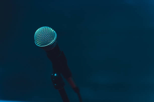 istock Microphone on stage against a background of auditorium. 1138048915
