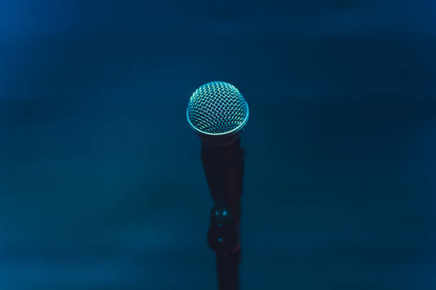 istock Microphone on stage against a background of auditorium. 1138048918