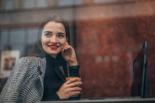istock Happy girl holding coffee 1138053624