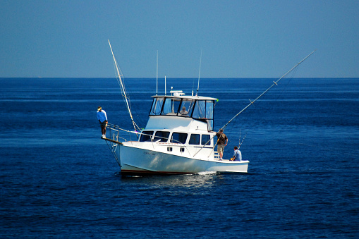 Sunrise view of fishing rod on charter fishing boat on the Pacific side of Cabo San Lucas in Baja California Mexico BCS