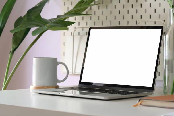 istock Mock up blank screen laptop in loft working space 1138064572