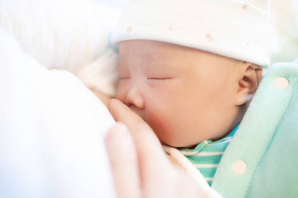 istock Mother feeding newborn baby 1138078198