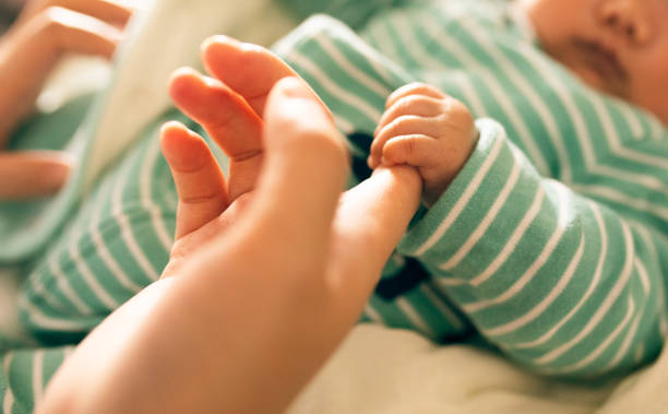 istock Newborn baby catch mother finger 1138078262