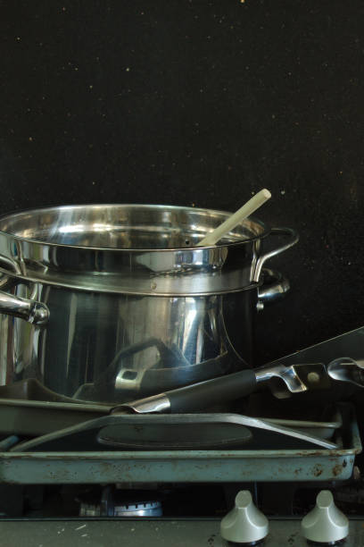 istock Dirty pans stacked on a stove. 1138079145