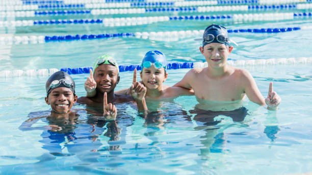 istock Multi-ethnic boys in swimming pool smiling at camera 1138080319