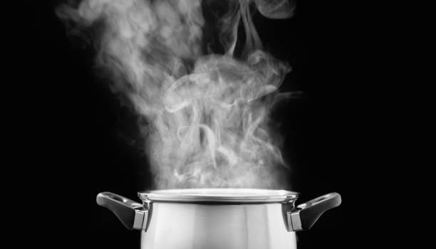 istock steam over cooking pot in kitchen on dark background 1138080358