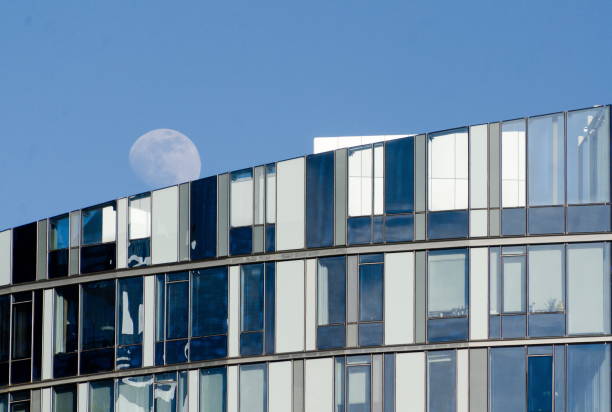 istock Full moon over glass wall of a skyscraper in Bellevue downtown 1138084190