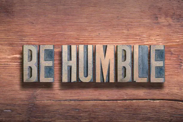 be humble phrase combined on vintage varnished wooden surface