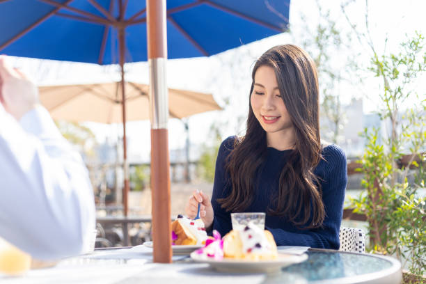 Woman Spending Holiday At Cafe On Open Terrace