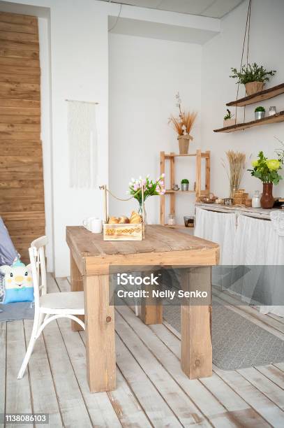 Summer Kitchen Interior In Rustic Style Bright Kitchen With A Wooden Table Spring Flowers And Bread In A Basket On The Table In The Kitchen Stock Photo - Download Image Now