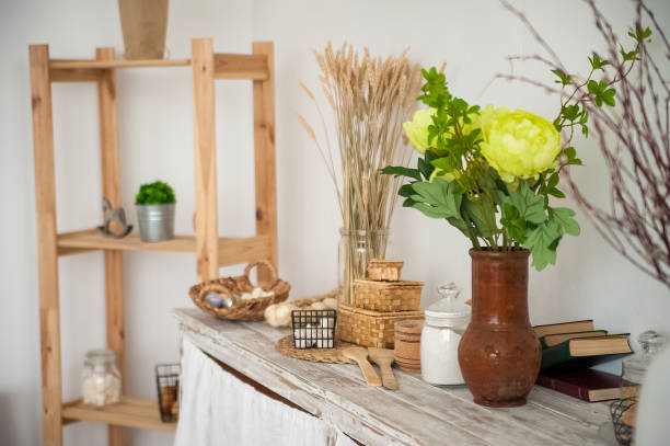 istock Summer kitchen interior in rustic style. Bright kitchen with a wooden table. Spring flowers and bread in a basket on the table in the kitchen 1138086112