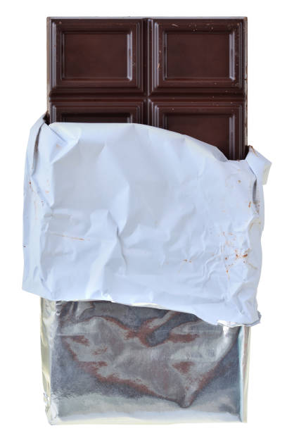 istock Dark chocolate bar in silver foil packaging top view isolated 1138086596
