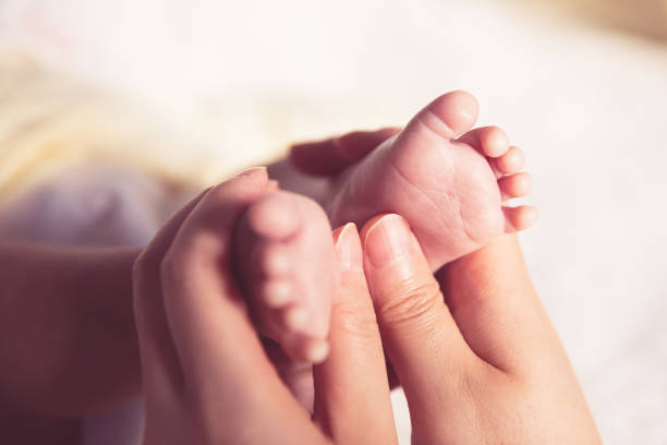 Newborn baby foot massage stock photo