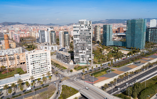 Aerial view of new residential complex of Diagonal Mar i el Front Maritim del Poblenou in sunny day, Barcelona, Spain