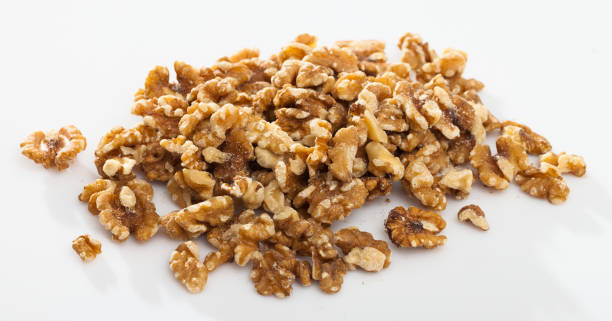 istock Pile of shelled walnuts on white surface 1138092516