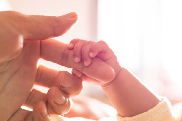 istock Newborn baby holding mother's hand 1138095355