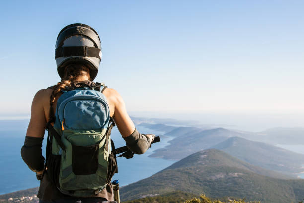 Woman Mountainbiker Looking At Island View stock photo
