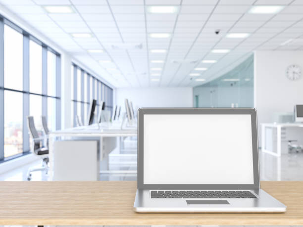 istock Laptop with wood empty surface and office building as background 1138097405