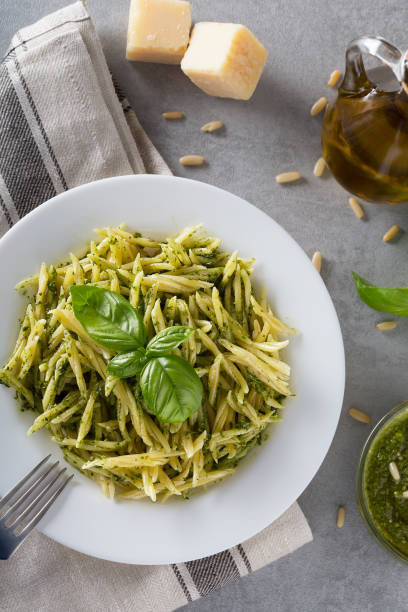istock Traditional trofie pasta with pesto sauce on white plate 1138098419