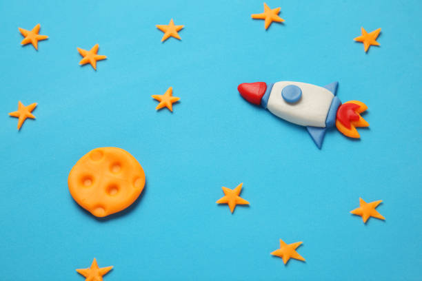 istock Creative craft plasticine rocket in open space, astronaut dreams. Stars, and moon. Cartoon ar 1138102202