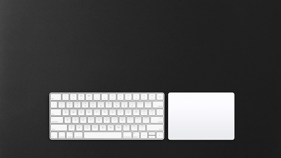 Computer track-pad and keypad on a dark background