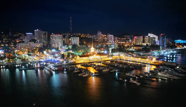 Sochi sea port. Aerial drone. Berth for marine yachts and boats. The historic building of the seaport. Evening illumination of the city. Sochi sea port. Aerial drone. Berth for marine yachts and boats. The historic building of the seaport. Evening illumination of the city. sochi photos stock pictures, royalty-free photos & images