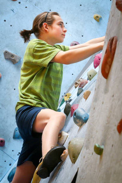 istock Teenage Boy Training Climbing On Indoor Climbing Wall 1138103834