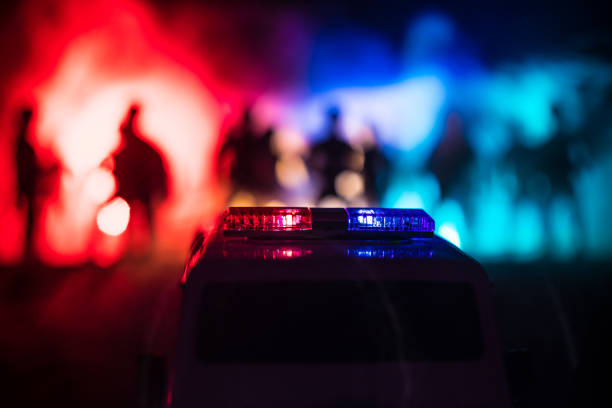 Police cars at night. Police car chasing a car at night with fog background. 911 Emergency response pSelective focus stock photo