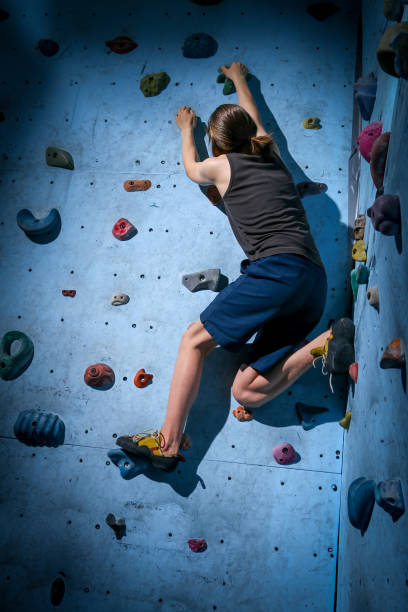 istock Teenage Boy Training Climbing On Indoor Climbing Wall 1138104035