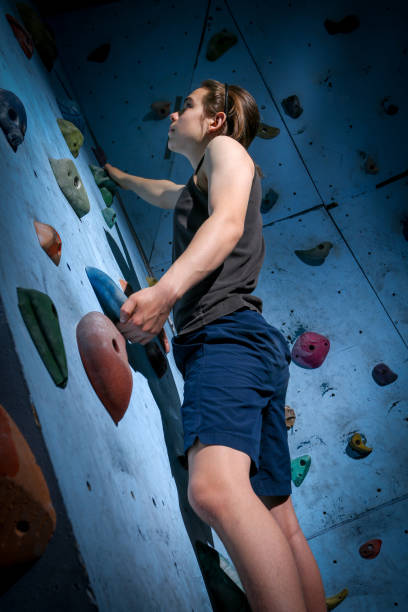 istock Teenage Boy Training Climbing On Indoor Climbing Wall 1138105101