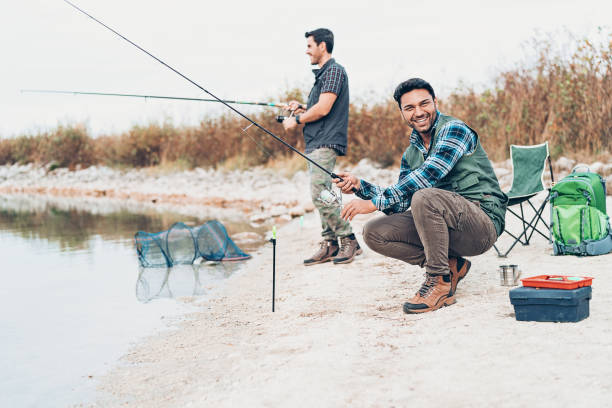 istock Two young men fishing together 1138105750