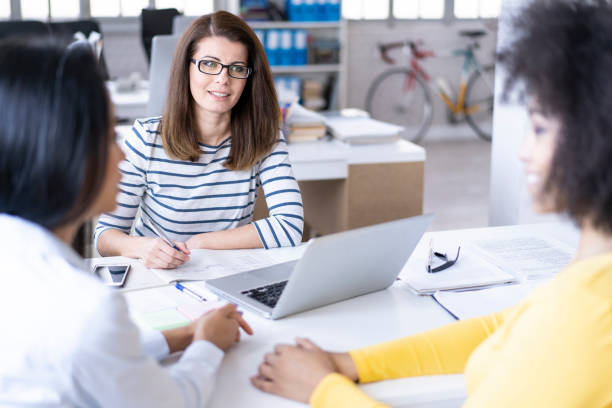 istock Three women sitting in office and talking 1138105762