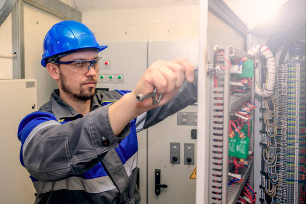 istock electromechanic in electrical safety gloves holds power cable, cabling connection of high voltage power electric line in industrial distribution fuseboard 1138107970