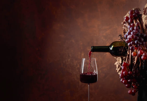 istock Red wine pouring into a glass. 1138108433