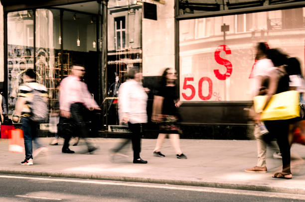 istock Motion blurred busy shopping street scene 1138124362