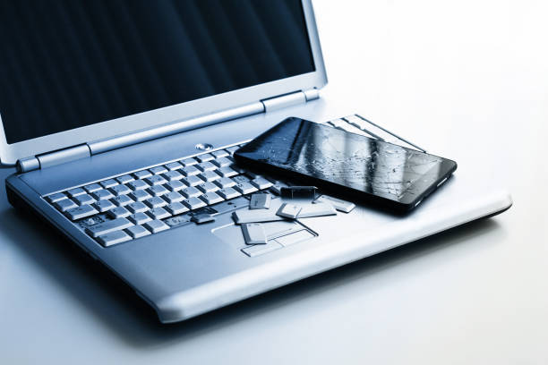 istock A silver laptop with a broken keyboard and a tablet with a cracked display. A close-up picture of part of broken laptop and cracked screen on a tablet. 1138127370