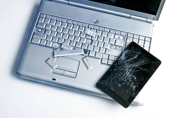 istock A silver laptop with a broken keyboard and a tablet with a cracked display. A close-up picture of part of broken laptop and cracked screen on a tablet. 1138127450